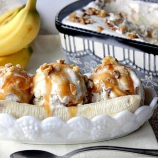 No Churn Banana Walnut Ice Cream in a ice cream dish with bananas and caramel sauce.