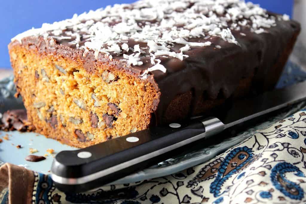 Chocolate Chip Dessert Loaf on a blue plate with a knife and a napkin