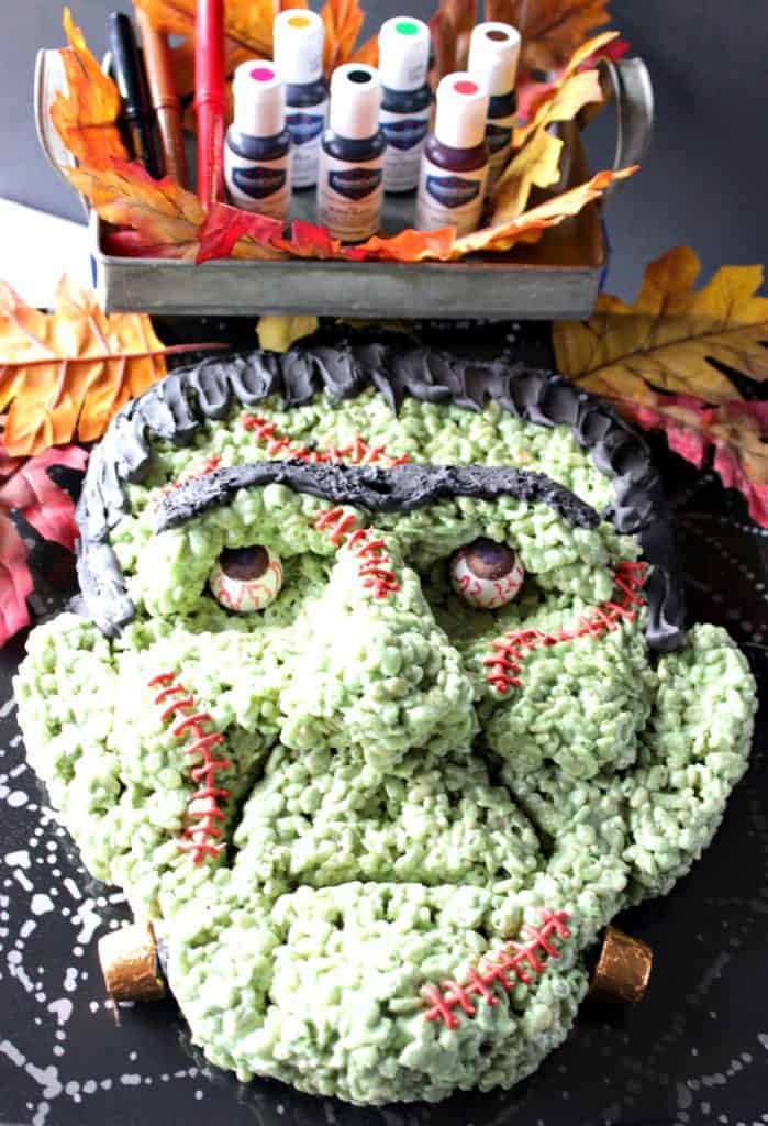 If you're intimidated or scared by the looks of this Frankenstein rice cereal Halloween treat because you think you wouldn't have success making him yourself, I'm here to prove you wrong! - Kudos Kitchen by Renee Overhead photos of Frankenstein Rice Kripsie Treat with gel food coloring