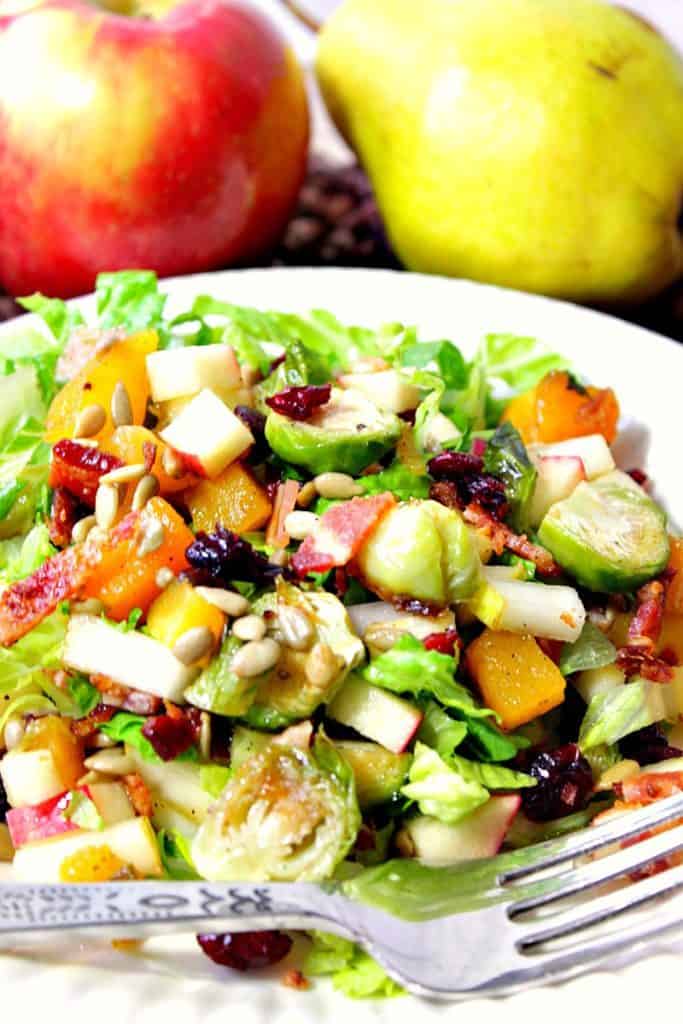 Closeup vertical photo of Thanksgiving chopped salad with bacon, Brussels sprouts, butternut squash and sunflower seeds.