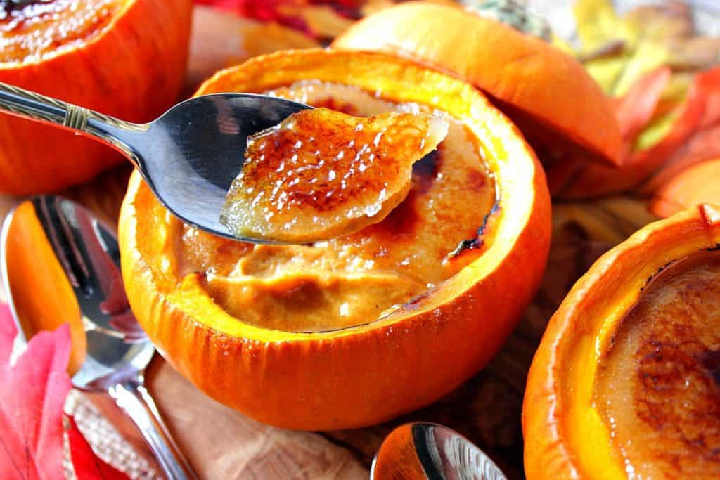 A closeup photo of a spoon with the caramelized sugar from a pumpkin creme brulee.