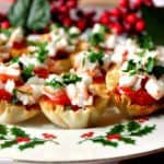 A plate filled with shrimp cocktail appetizer bites with cocktail sauce and parsley.