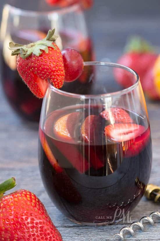 Closeup photo of sangria with strawberries. New Year's eve appetizers and drinks recipe roundup.