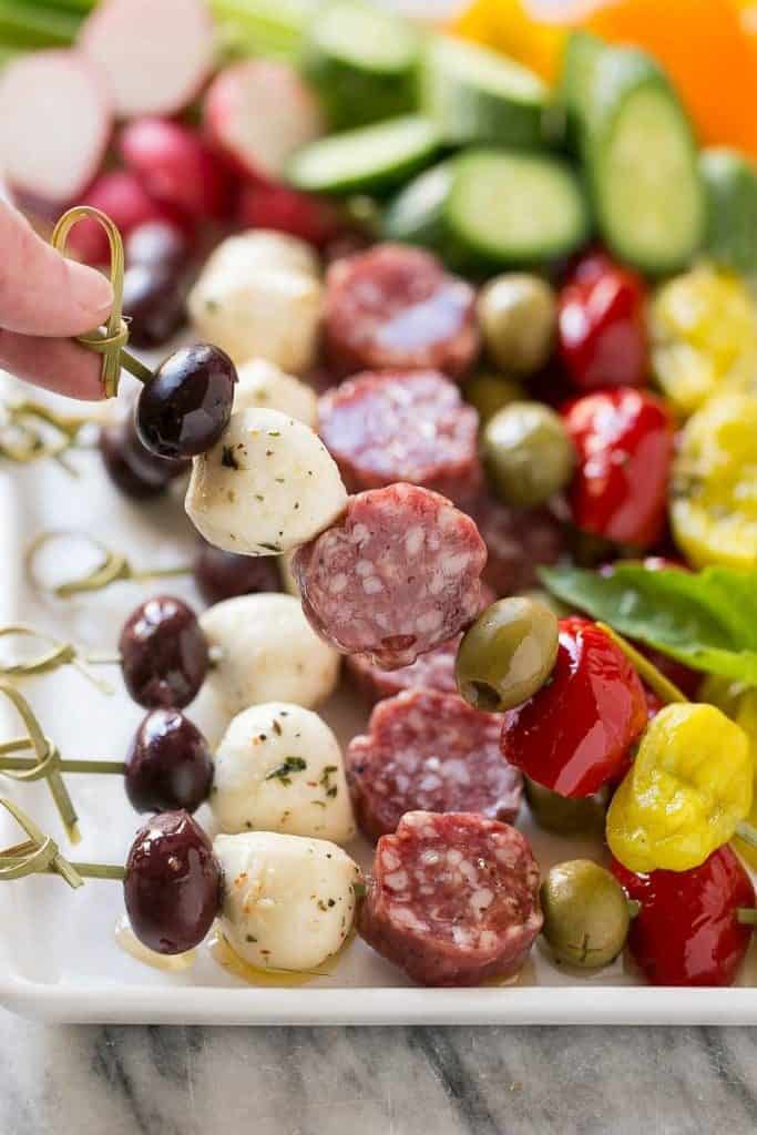 Colorful closeup of a antipasti skewer. New Years eve appetizers and drinks recipe roundup.