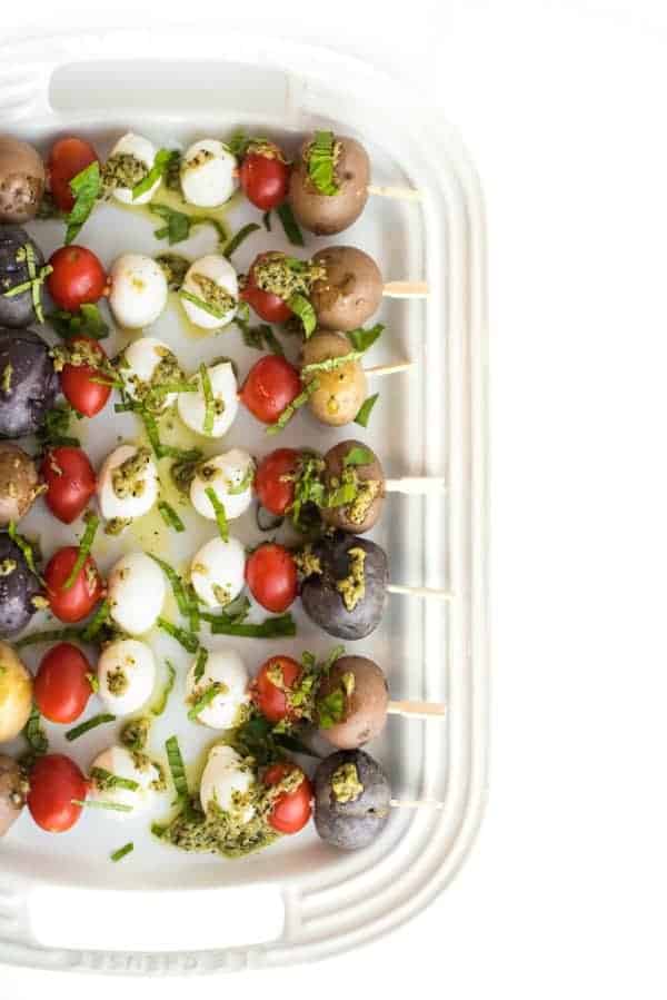 Colorful overhead photo of skewers in a dish. New Years eve appetizers and drinks recipe roundup.