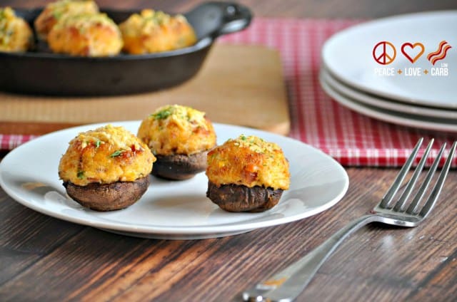 Three stuffed mushrooms on a plate. New Years eve appetizers and drinks recipe roundup.