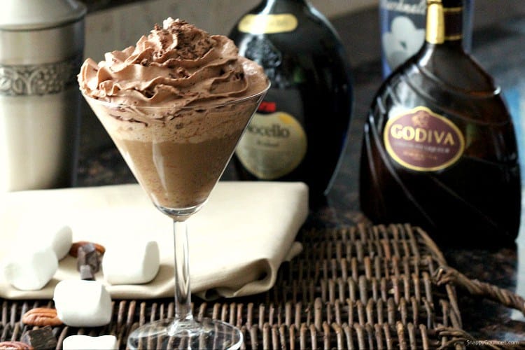 Chocolate cocktail in a martini glass with marshmallows. New Years eve appetizers and drinks recipe roundup.