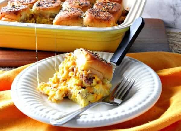 Scrambled Egg Breakfast Slider on a white plate with a casserole dish in the background.