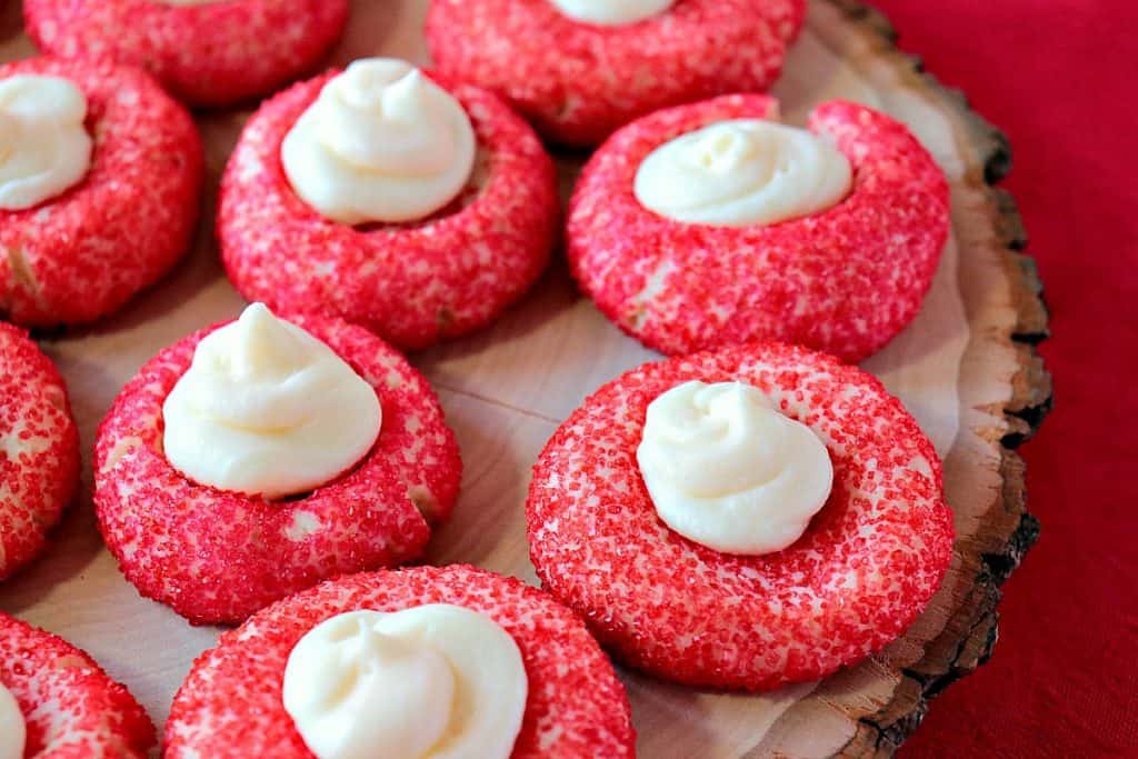 Closeup photo of a tray of red Cream Cheese Cookies with Cheesecake Topping