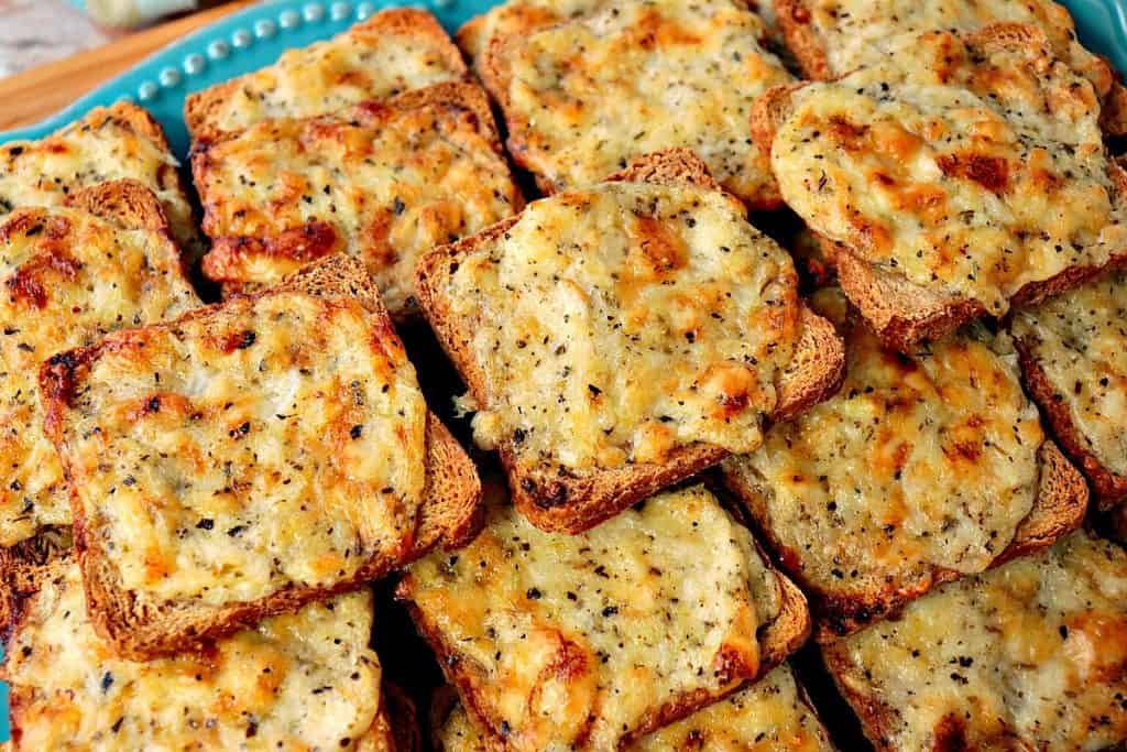 Horizontal photo of Parmesan onion appetizer squares for Thanksgiving and fall appetizer recipe roundup.