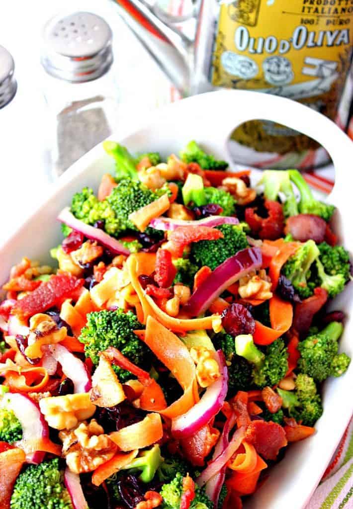 Healthy Broccoli Salad with carrots, walnuts, bacon, cranberries, and red onion. | Kudos Kitchen by Renee