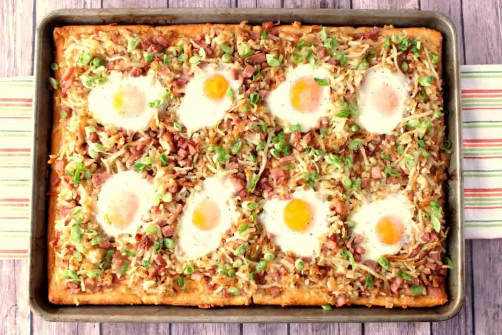 Make this Sunny Side Up Hash Brown Breakfast Pizza for breakfast, brunch or even dinner. Whichever you choose, it's always a winner! - Kudos Kitchen by Renee - www.kudoskitchenbyrenee.com Hash Brown Breakfast Pizza with Eggs and Cheese - www.kudoskitchenbyrenee.com