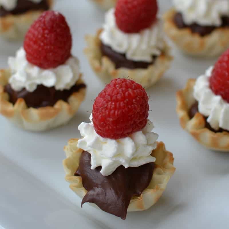 Mini chocolate tarts with raspberries on top for easy chocolate dessert recipes for Valentine's day