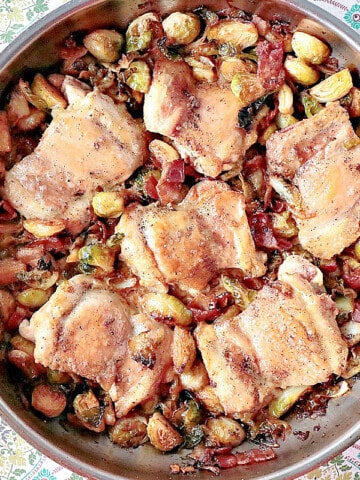 A look into a silver skillet filled with Chicken Thighs with Brussels Sprouts and Bacon.