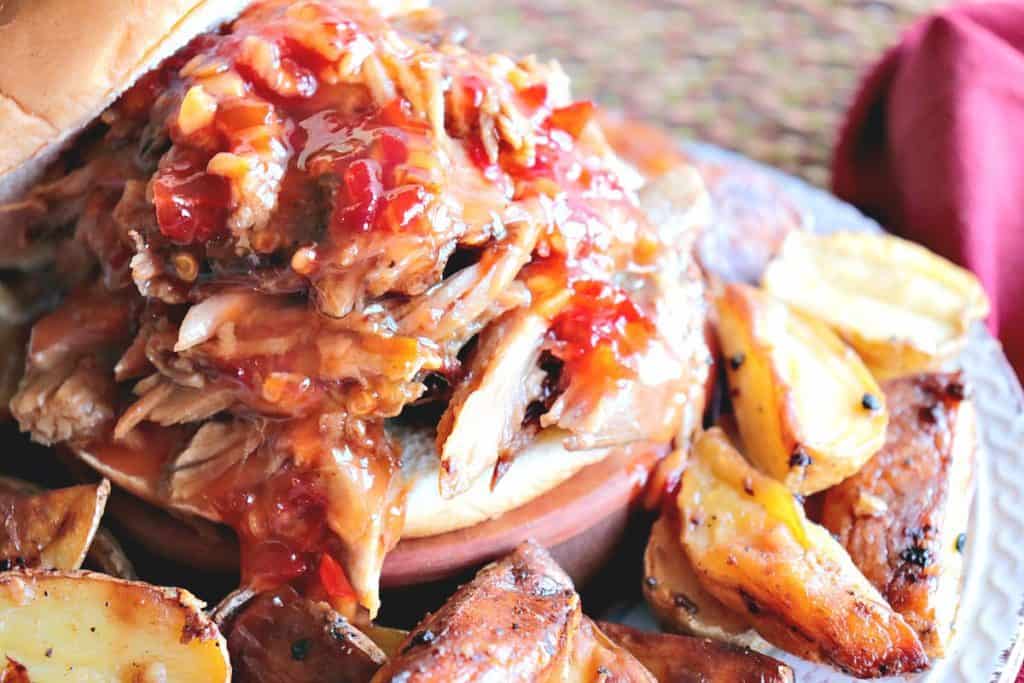 Sweet with a little heat. That's what you'll find in this delicious Spicy Thai Pulled Pork recipe. Mix everything up in the slow cooker and then go about your day. You really can't get much easier (or tastier) than that! And it feeds a crowd, too!! - www.kudoskitchenbyrenee.com Spicy Hair Pulled Pork with Orange for the Slow Cooker Sandwich - www.kudoskitchenbyrenee.com