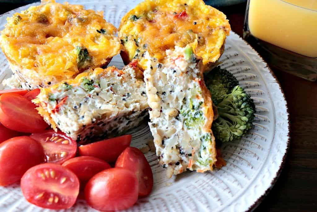 A healthy Quinoa Veggie Egg White Cup on a white plate with tomatoes.