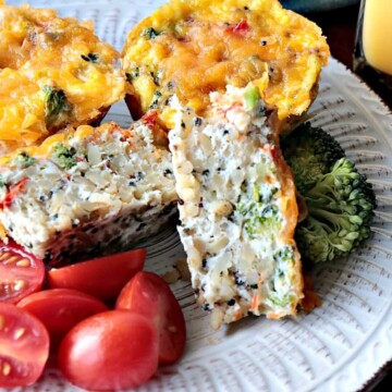 A healthy Quinoa Veggie Egg White Cup on a white plate with tomatoes.