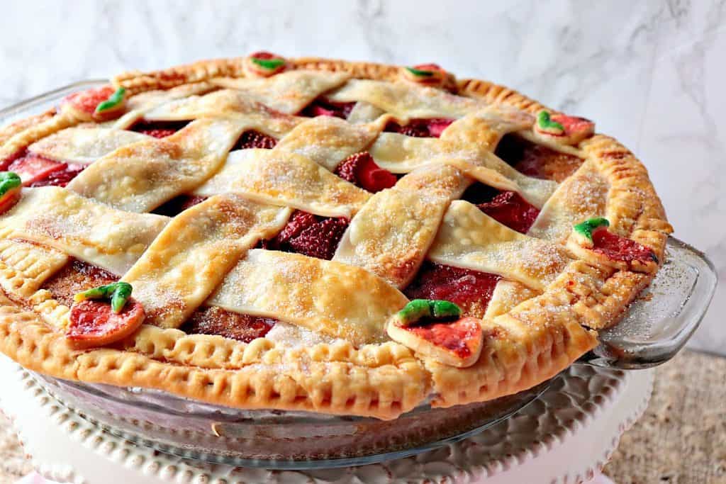 Lattice topped strawberry orange pie cake with strawberry pie crust accents.