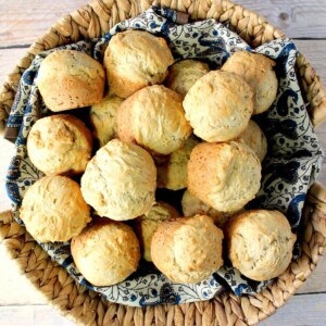 A basket filled with golden brown Beer Bread Biscuits.