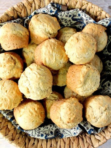 A basket filled with golden brown Beer Bread Biscuits.