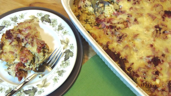 A casserole filled with corned beef hash strata and a plate with green leaves and a fork for a popular St. Patrick's day recipes roundup post.