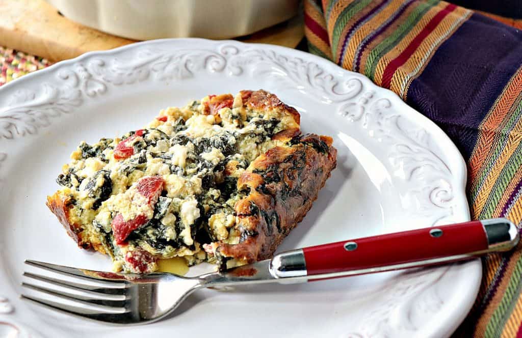 This Keto Creamed Spinach Casserole is a super easy low carb side dish that is a perfect accompaniment to any main course entree. Or it can be the main course itself if you're living a vegetarian lifestyle or keto. - www.kudoskitchenbyrenee.com Keto Creamed Spinach Casserole with roasted red pepper and heavy cream. - www.kudoskitchenbyreneecom