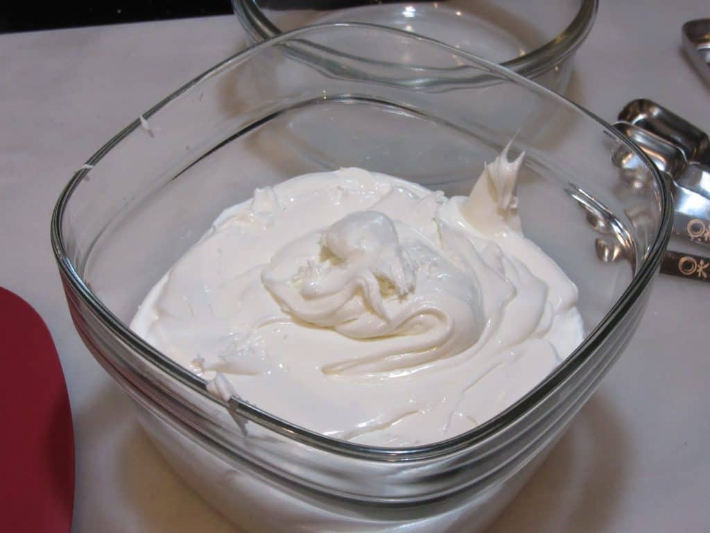 A bowl of royal icing getting ready for storage.