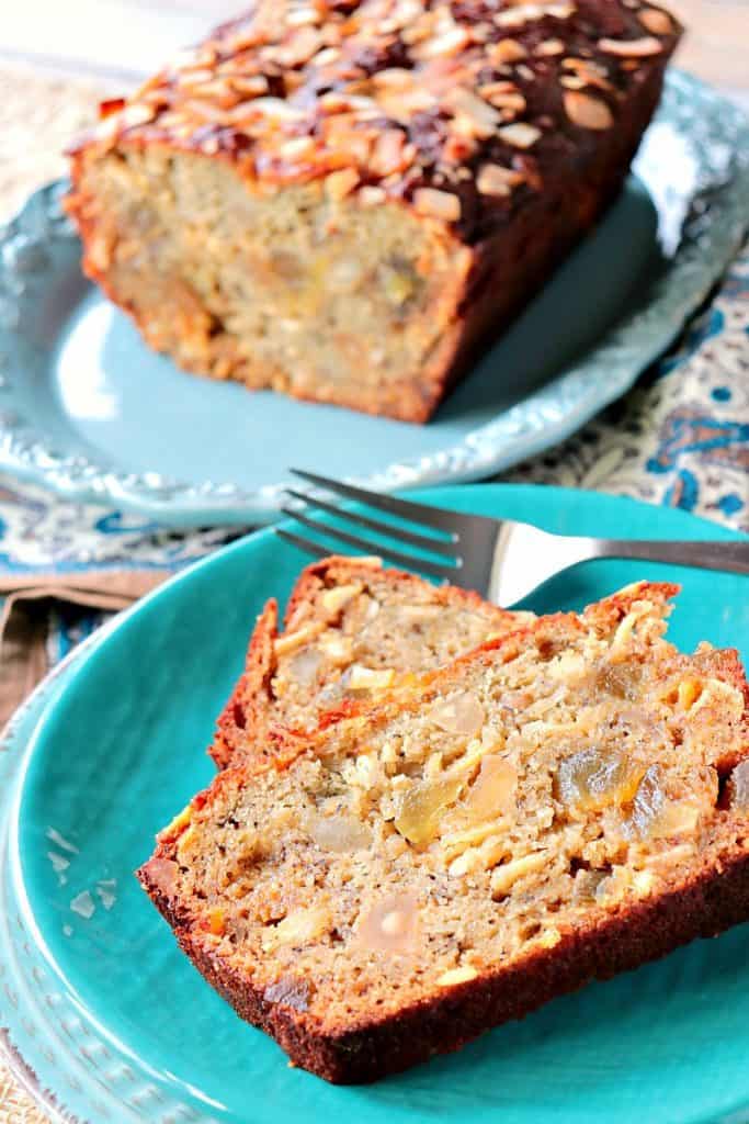 A few slices of Gluten Free Tropical Quick Bread on a blue plate with a fork.