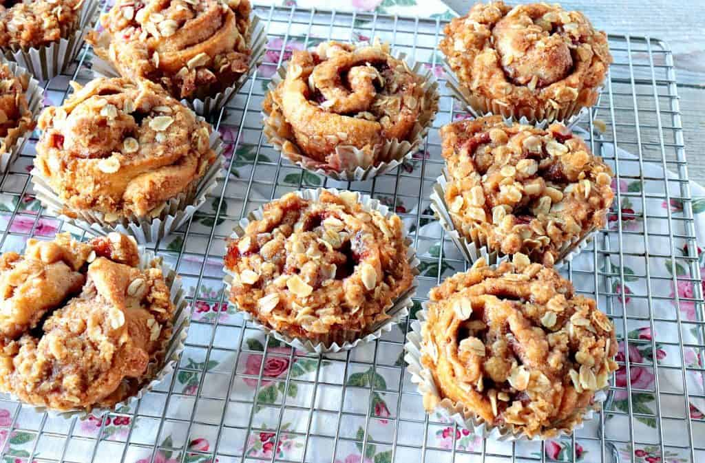 Overhead photo of a bunch of strawberry crescent muffins on a baking rack to cool.