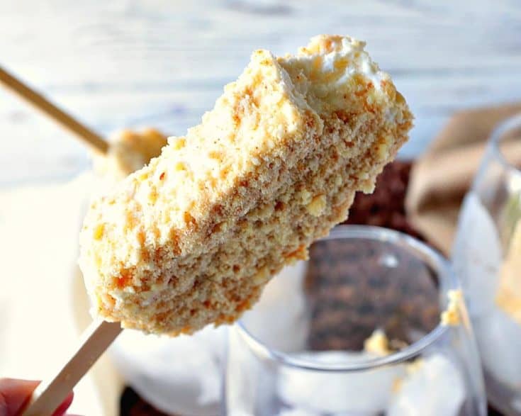 A closeup photo of a toasted almond ice cream bar with a bite taken out.