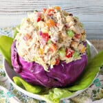A red cabbage bowl filled with Chicken Salad with Apricots.