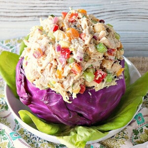 A red cabbage bowl filled with Chicken Salad with Apricots.