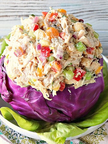 A red cabbage bowl filled with Chicken Salad with Apricots.