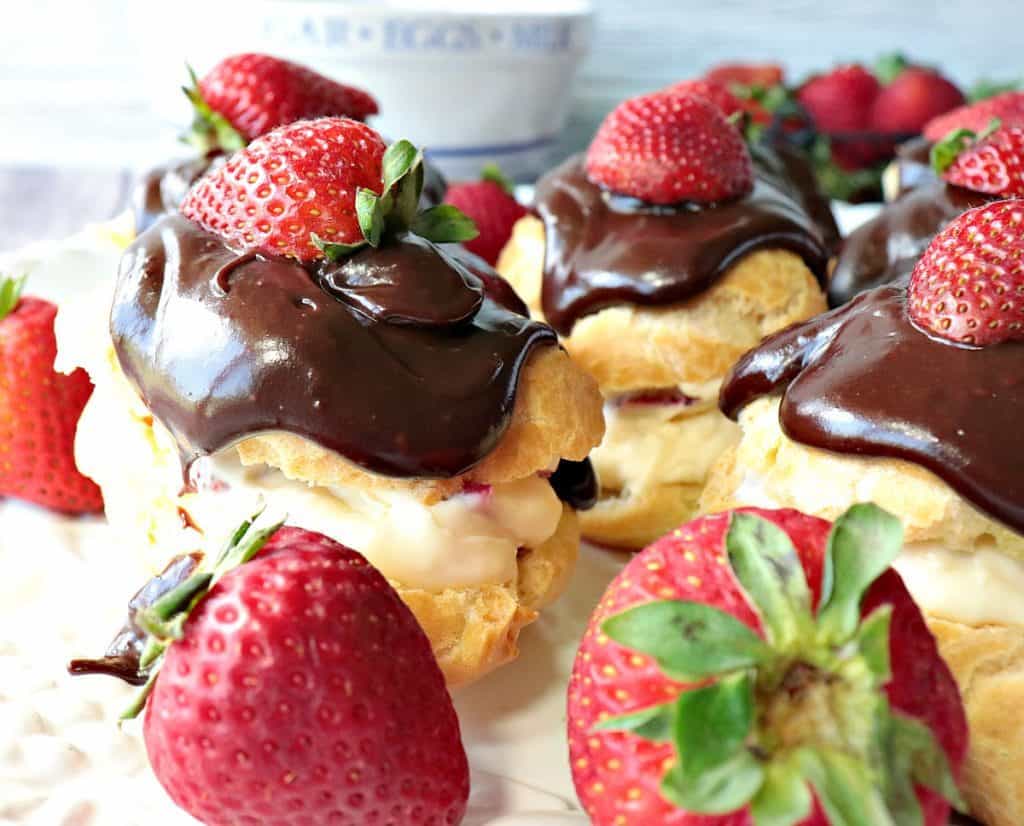 Closeup photo of a strawberry filled eclair with a chocolate ganache topping.