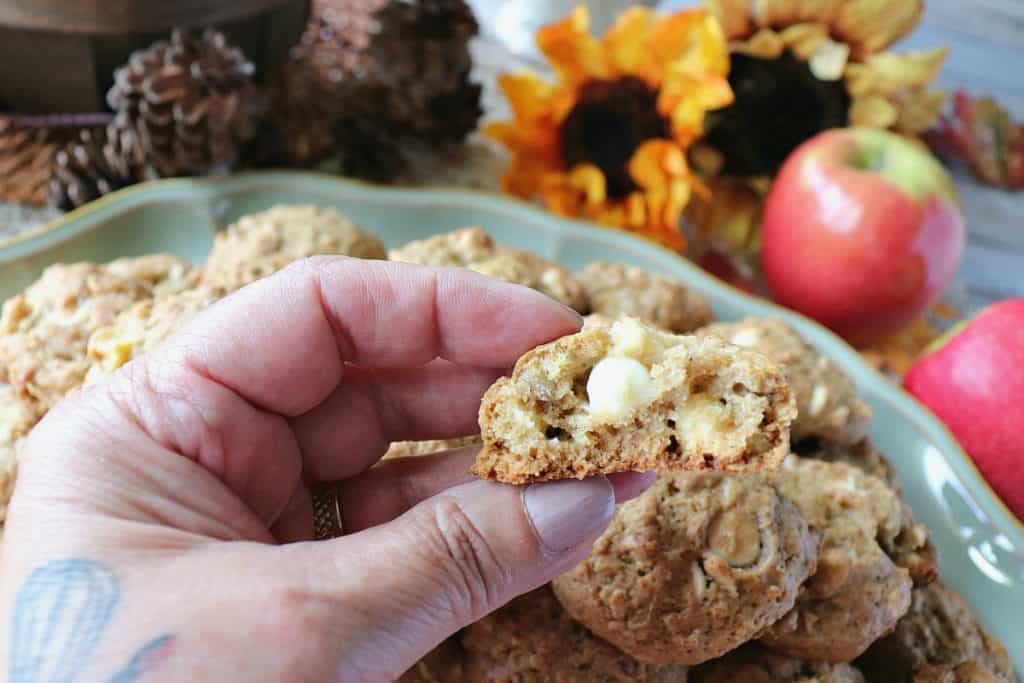 A hand holding an Apple Oatmeal Cookie with bites taken out.