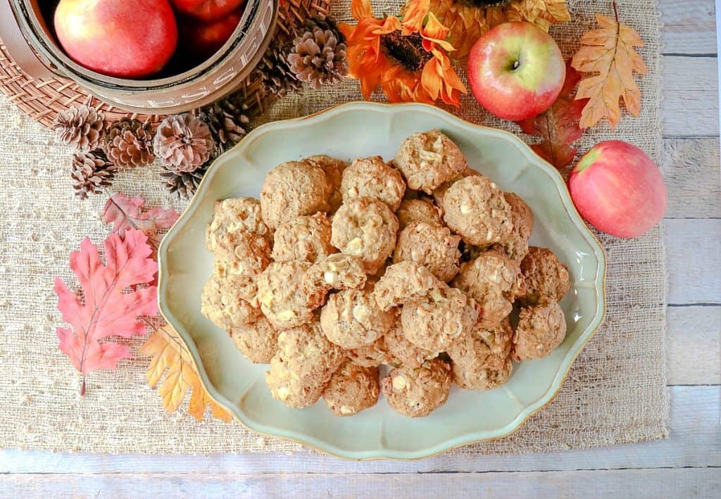 Overhead photos of a plate of  Apple Oatmeal Cookies  with apples, leaves and pinecones in the background.