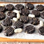 Sugar Free Chocolate Peanut Butter Cookies and peanuts on a board