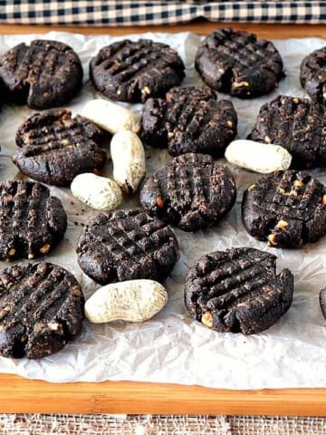 Sugar Free Chocolate Peanut Butter Cookies and peanuts on a board