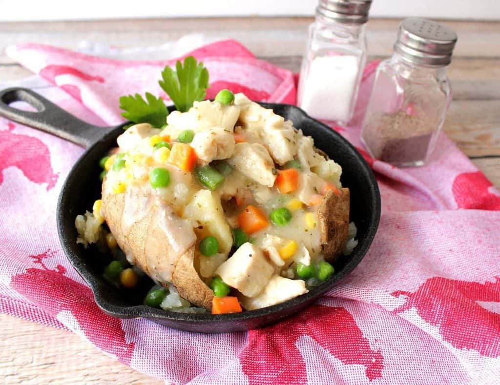 Easy Weeknight Dinner Recipes of a chicken pot pie potato in a cast iron skiller.