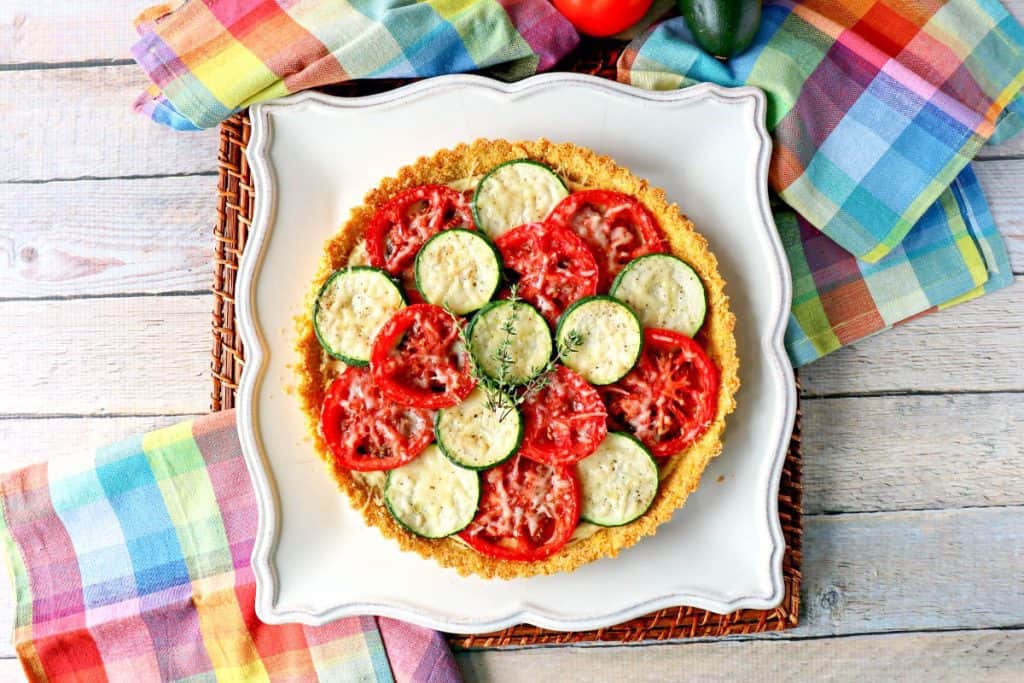 Late summer vegetables beckon to be nestled into this Fresh Tomato Tart with Zucchini & Caramelized Onions. - kudoskitchenbyrenee.com