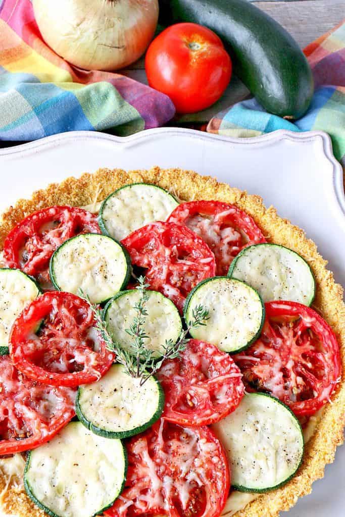 Late summer vegetables beckon to be nestled into this Fresh Tomato Tart with Zucchini & Caramelized Onions. - kudoskitchenbyrenee.com