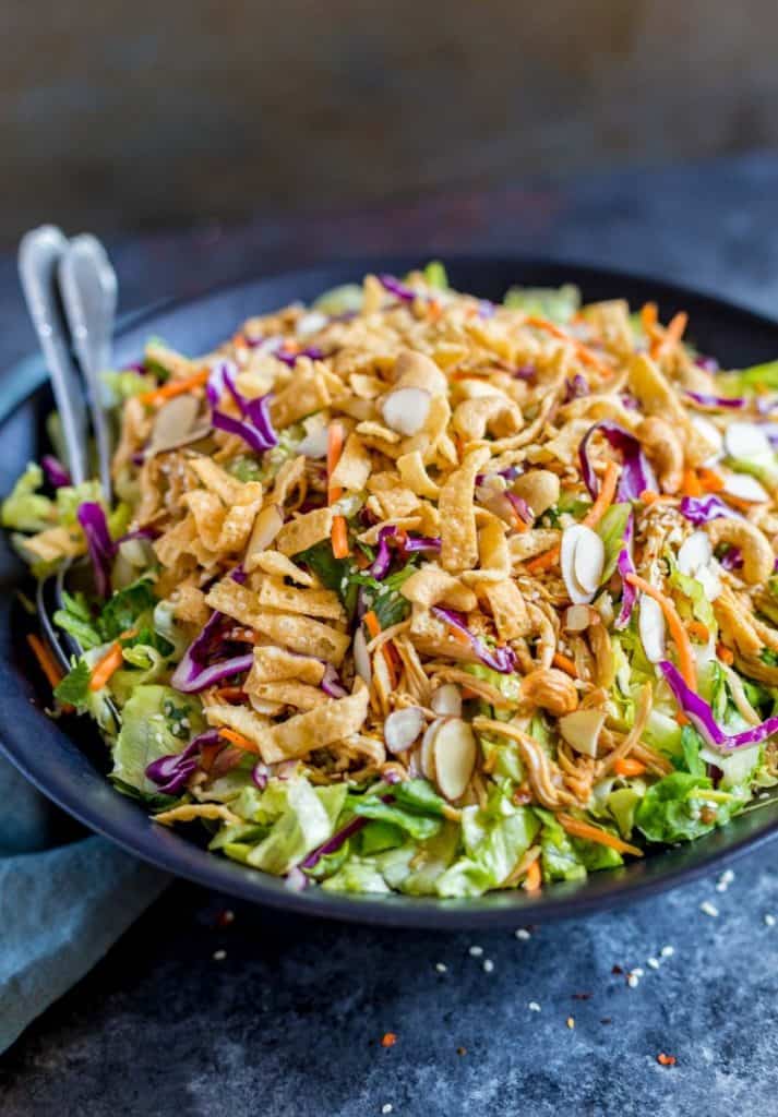 Easy Weeknight Dinner Recipes. Colorful salad in a black bowl with almonds and a crunchy topping.