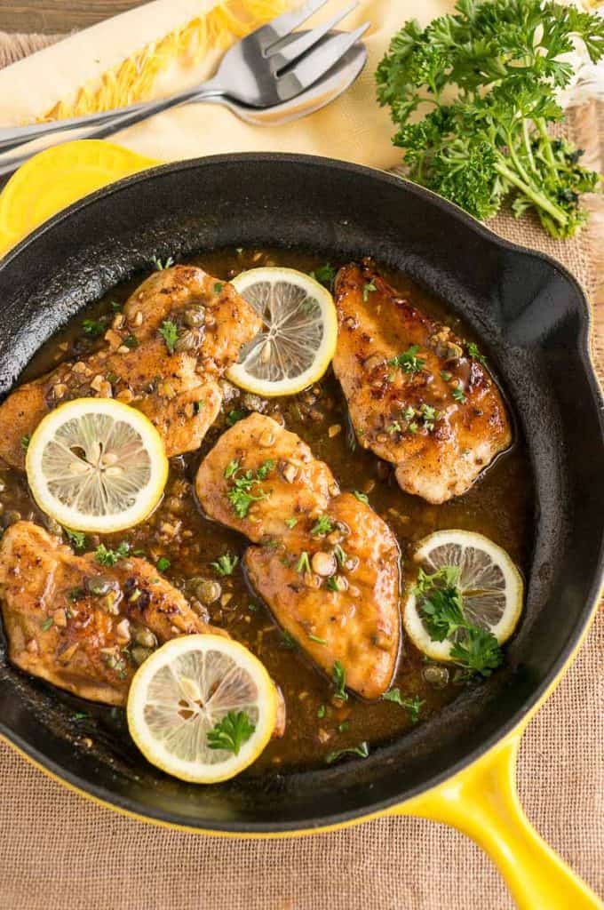 Easy Weeknight Dinner Recipes. Chicken Picatta in a cast iron skillet with lemon and parsley.