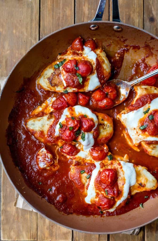 Easy Weeknight Dinner Recipes. Chicken in a skillet with cheese and tomatoes.