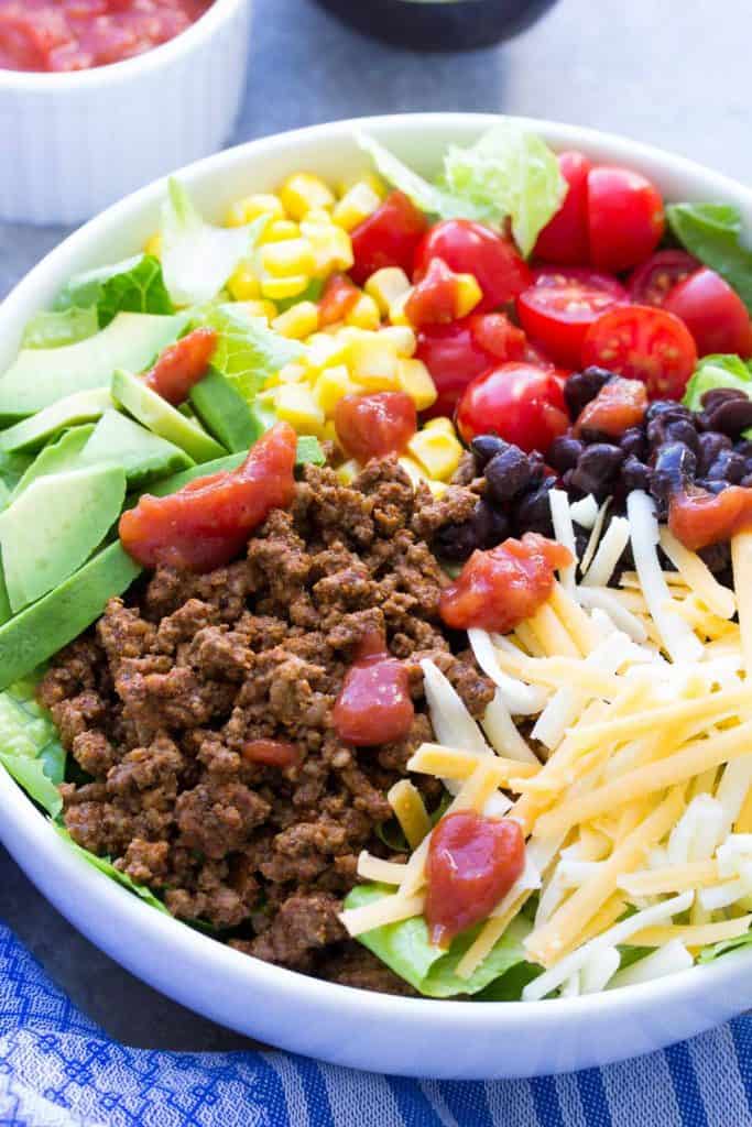 Easy Weeknight Dinner Recipes. Colorful taco salad in a white bowl.