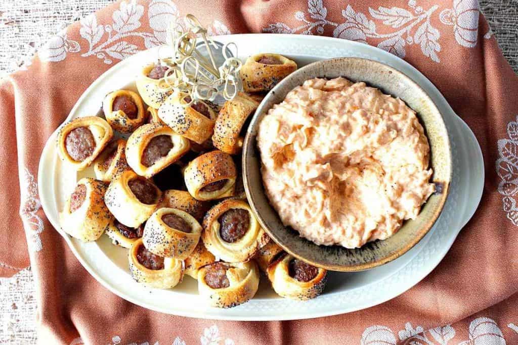 Overhead photos of a tray of bratwurst bites with dipping sauce in a bowl.