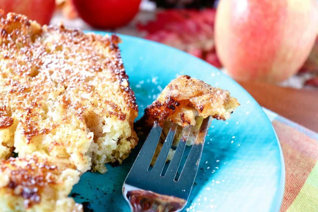 Extreme closeup of a bite of no knead apple yeast bread on a fork.