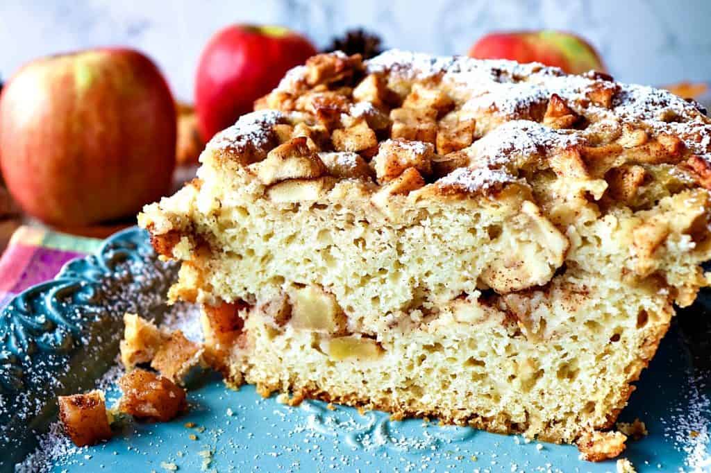 No-Knead Apple Yeast Bread on a blue plate with apples in the background.