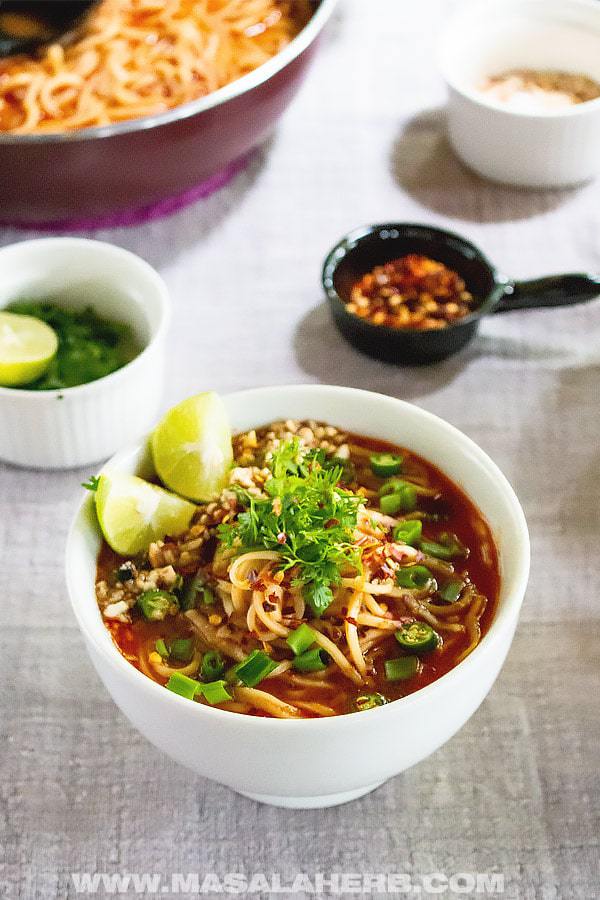 Easy Weeknight Dinner Recipes. Small white bowl of Asian noodles and sauce with lime and scallions.
