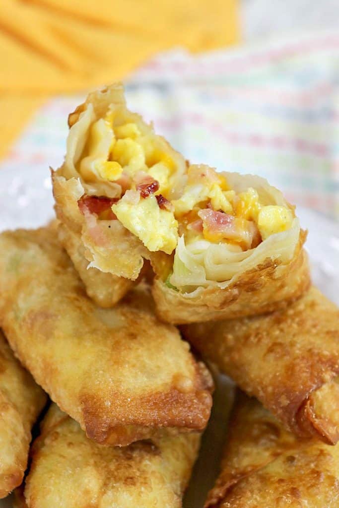 Very closeup photo of the inside of a breakfast eggroll with scrambled eggs and bacon.